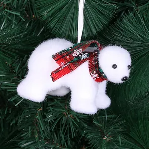Close-up of a plush white polar bear Christmas tree ornament with a plaid scarf