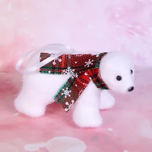 Close-up of a white plush polar bear ornament with a red plaid snowflake scarf