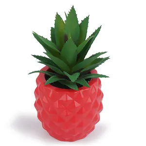 Macro view of red resin pineapple planter with lifelike green faux succulent detail