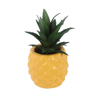 Macro view showing the detailed texture of the yellow pineapple resin succulent pot.