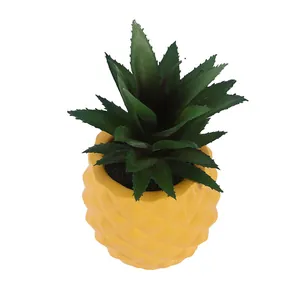 Realistic yellow resin pineapple planter with artificial green succulent plant decor