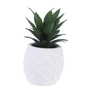 Detailed view of resin pineapple succulent planter with green artificial leaves