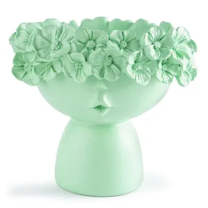 Macro detail of a mint green Nordic style creative face planter with flower crown
