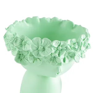 Detailed view of a mint green Nordic head-shaped succulent planter with a flower crown