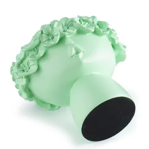 Detailed view showing the black non-slip felt base of a mint green Nordic art resin planter.