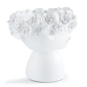 Detailed view of a white Nordic resin head planter featuring a delicate floral crown relief