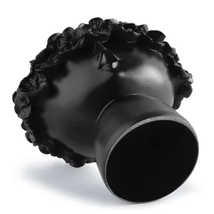 Detailed view of a black Nordic artistic head planter showing bottom and matte texture.