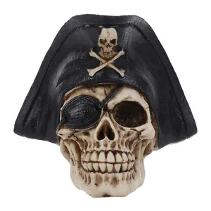Detail view of a realistic resin pirate skull figurine with hat and eye patch for decoration.