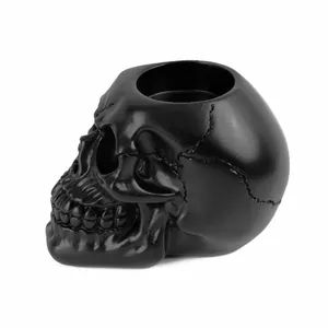 Close-up detail of a matte black resin skull ashtray, perfect for gothic home decoration