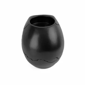 Macro view of matte black resin skull ashtray showing textured crack details