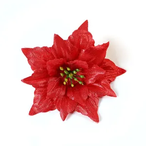 Top view of a bright red artificial poinsettia flower ideal for Christmas tree decoration.