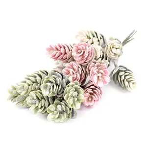 Close-up detail of artificial pine cone bouquet with soft pink and green flocked textures