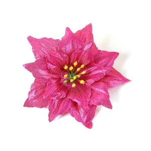 Macro view of artificial hot pink poinsettia flower with detailed fabric petals and stamens