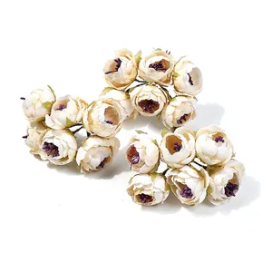 Vista dettagliata di mini bouquet di fiori artificiali crema con stami viola per fai da te.