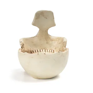 Detailed view of skull-shaped resin eyeglass holder with weathered bone texture