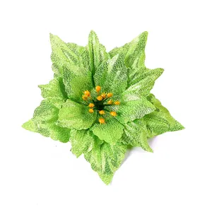 Detailed view of bright green artificial Christmas poinsettia flower for wreaths and trees