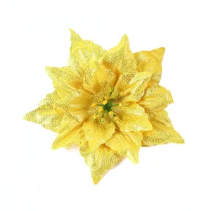 Detail shot of a sparkling yellow glitter artificial poinsettia flower for Christmas decor