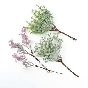 Detailed view of three varieties of artificial plastic sprigs for DIY home decor