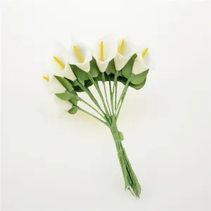 Close-up of mini white PU calla lilies with yellow spadix for DIY wedding favors