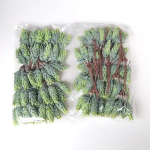 Bulk pack of artificial frosted green pine cone clusters with brown stems in clear bags