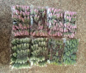 Detail showing eight packs of artificial pineapple grass and pine cone bouquets