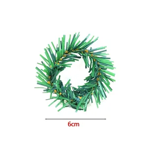 Detailed view of a six centimeter diameter green artificial Christmas wreath napkin ring