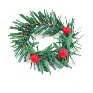 Detailed view of a green Christmas wreath napkin ring with glossy red berries