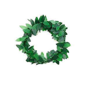 Detail view of artificial green leaf napkin ring with realistic leaf texture for table