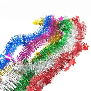Macro detail of colorful Christmas star tinsel garlands in red silver green blue gold