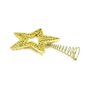 Detailed macro view of a golden hollow filigree star Christmas tree topper ornament.