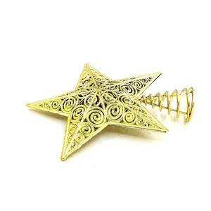 Detailed view of golden hollow-out star Christmas tree topper with spiral design