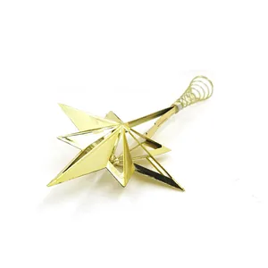 Detail view of a gold plated five-pointed Christmas tree topper star with spiral base