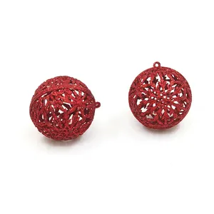 Close-up of 6cm red glitter hollow Christmas baubles featuring intricate snowflake patterns
