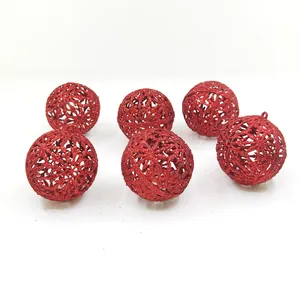 Close-up detail of red hollowed-out glitter Christmas ball ornaments for tree decoration
