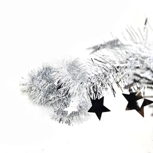 Close-up of silver tinsel garland with black and silver star accents for holiday decor.