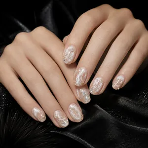 Close-up of elegant white feather nail art stickers with small pearls on black satin