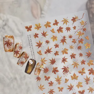 Metallic autumn maple leaf nail art stickers with gold and reddish-brown shimmer