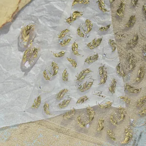 Detailed view of vintage gold feather nail art stickers with elegant metallic texture