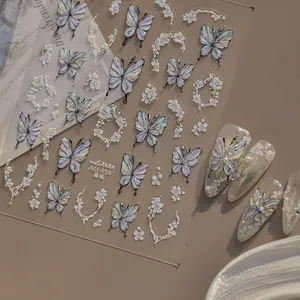 Detailed macro view of 3D butterfly nail art stickers with iridescent finish