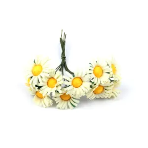 Detailed close-up of mini artificial white daisies with yellow centers and green stems.