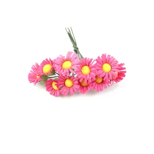 Small artificial pink daisies with yellow centers and green wire stems for DIY crafts