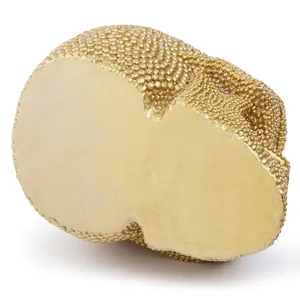 Detailed bottom view of a golden resin skull mask with textured diamond-encrusted beads