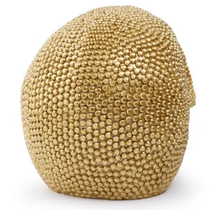 Close-up macro view showing the dense gold rhinestone texture of the Halloween skull mask