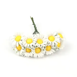 Detailed close-up view of small white artificial daisy flowers with realistic yellow centers