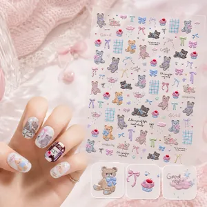 Detailed view of 3D embossed cute bear and bow nail stickers applied on nails