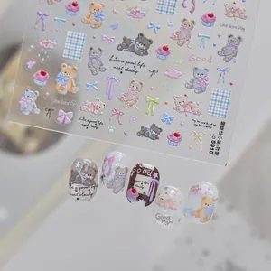 Detailed macro view of 5D embossed cute bear and bow nail art stickers with textured patterns.