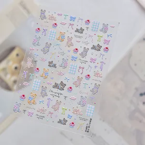 Detailed macro shot of 3D embossed nail art stickers with bear and bow designs