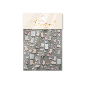 Detailed close-up of cute 3D embossed nail stickers featuring bears and colorful bows.