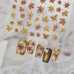 Detail view of metallic red-brown maple leaf nail art stickers with application sample