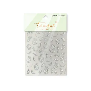 Detailed macro view of vintage metallic silver feather nail stickers with crystal accents